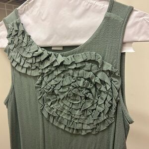 Design history green blouse with ruffles on front
